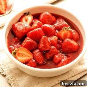 4-Ingredient Strawberry Compote Recipe for Fresh Homemade Jam 9 Beige surface with white bowl containing strawberry compote.