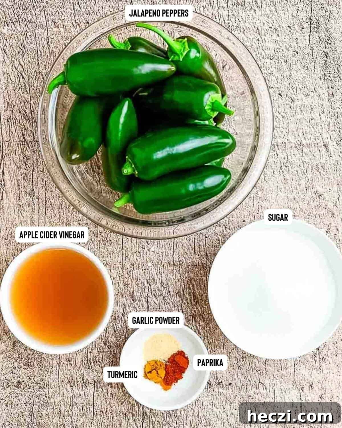 Small-Batch Cowboy Candy Canning Recipe for Spicy Candied Jalapeños 3 Ingredients for cowboy candy on a wooden table.