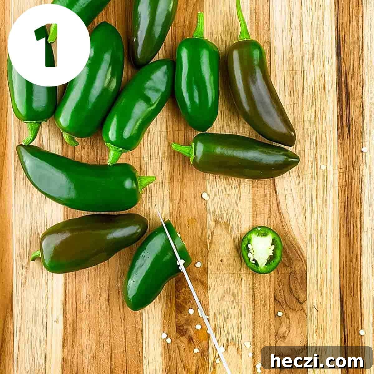 Small-Batch Cowboy Candy Canning Recipe for Spicy Candied Jalapeños 4 A knife slicing jalapeno peppers into quarter inch rings.