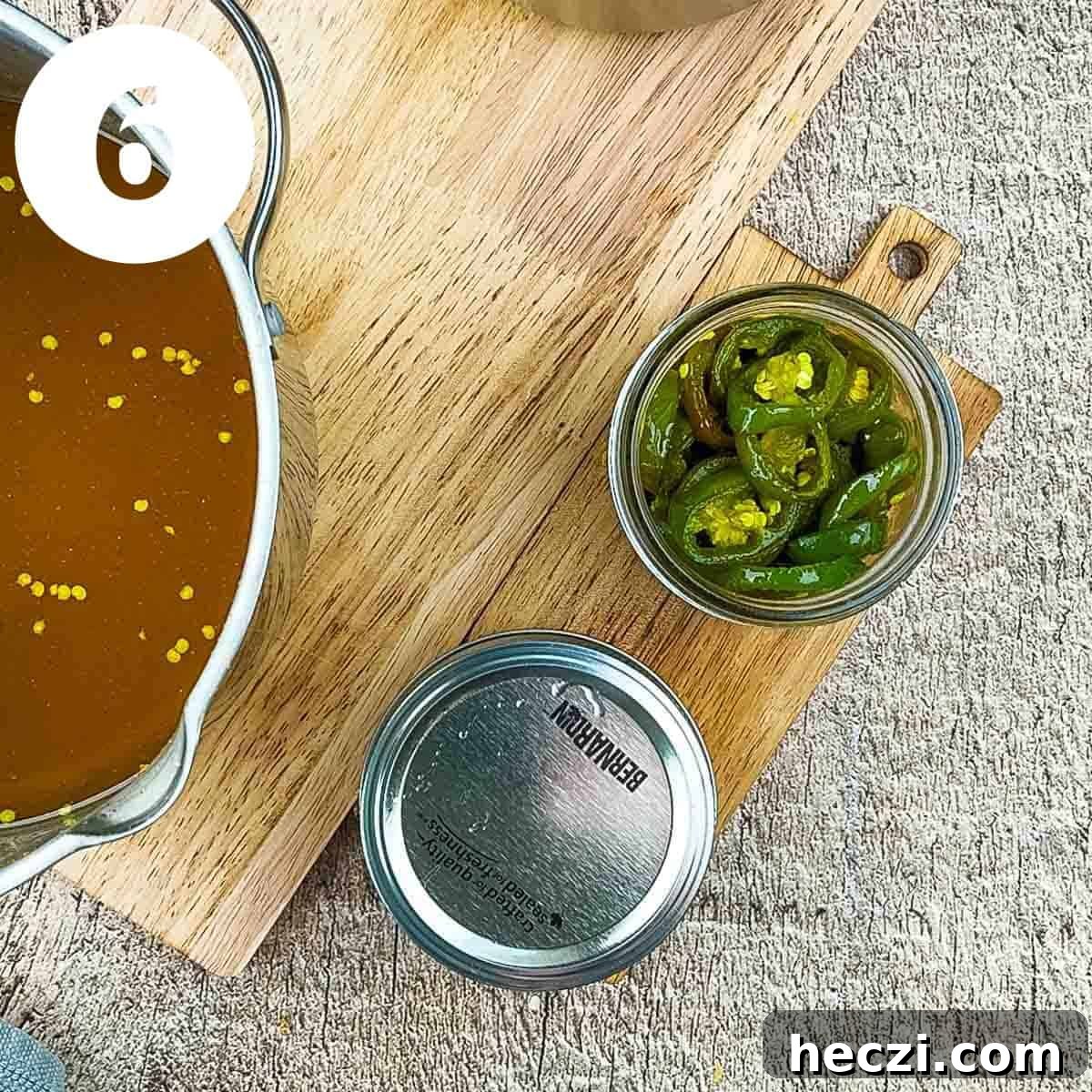 Small-Batch Cowboy Candy Canning Recipe for Spicy Candied Jalapeños 9 A lid and screw cap on one jar, with the other ready to be filled with liquid.