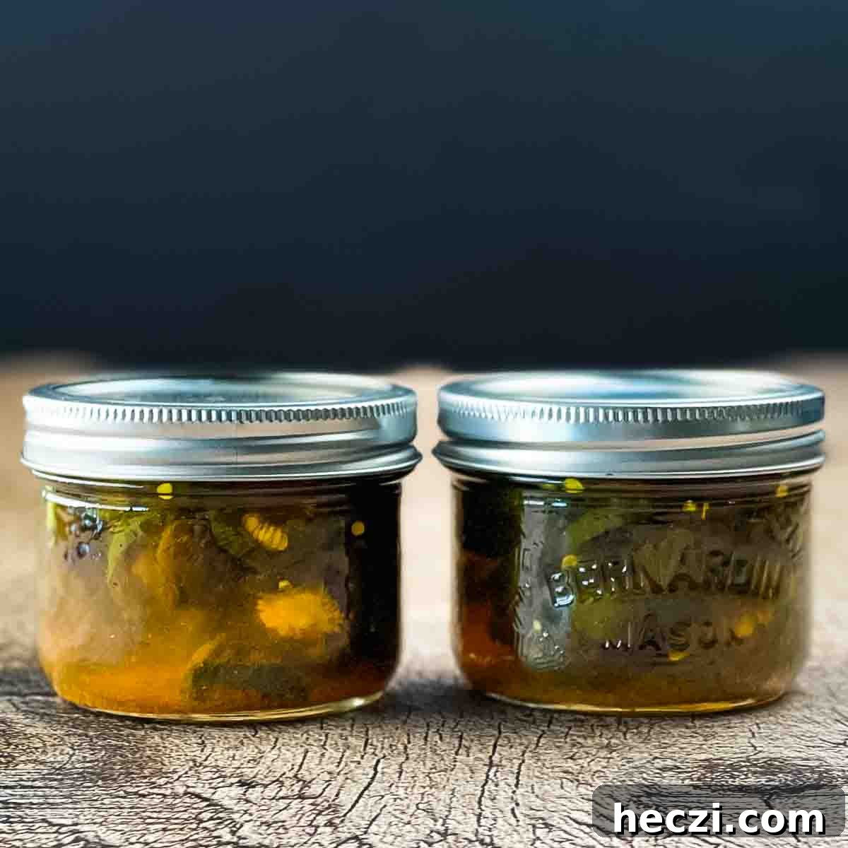 Small-Batch Cowboy Candy Canning Recipe for Spicy Candied Jalapeños 10 Two half-pint jars of cowboy candy on a wooden counter.