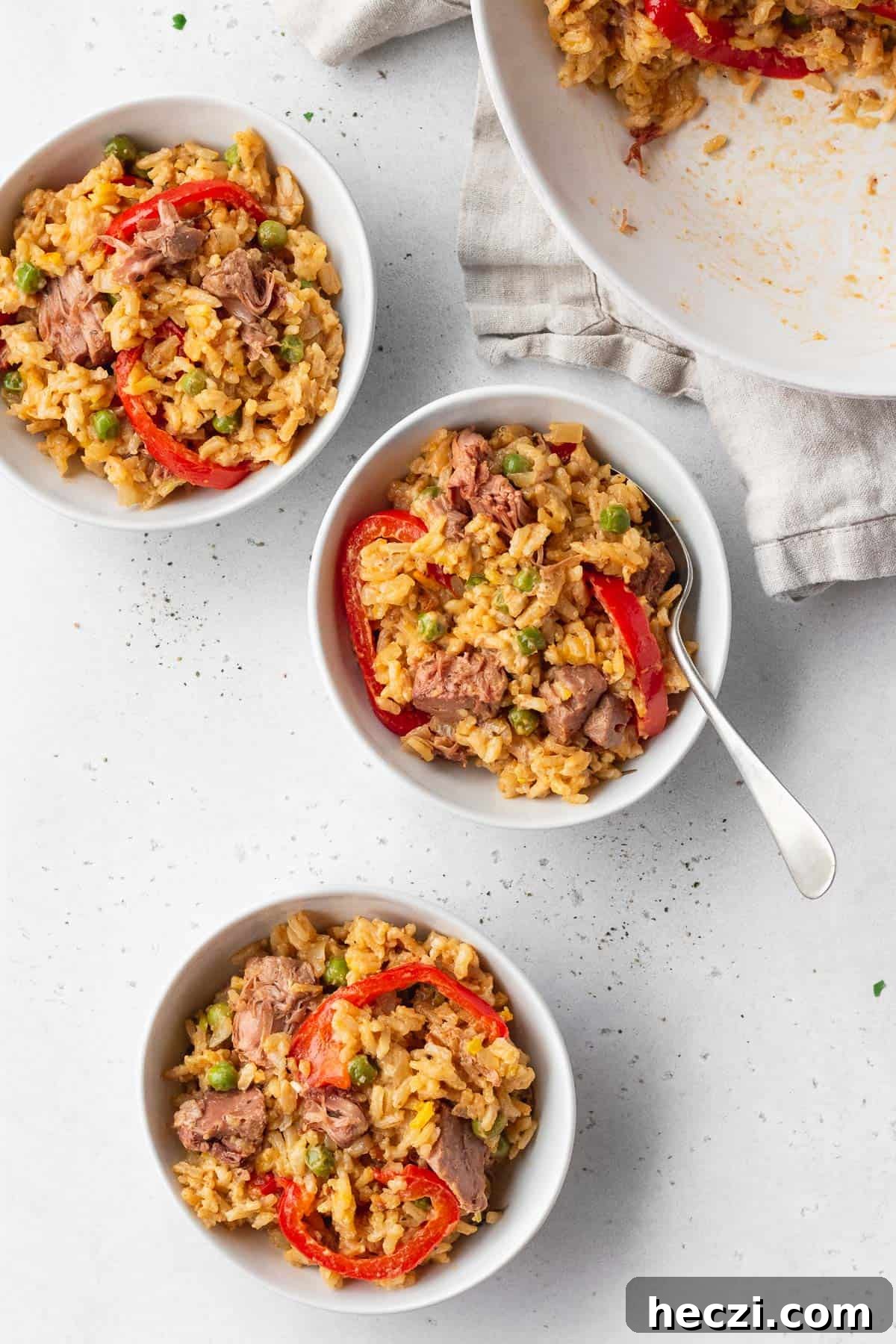 3 bowls of vegan Arroz a la Valenciana on a white table.
