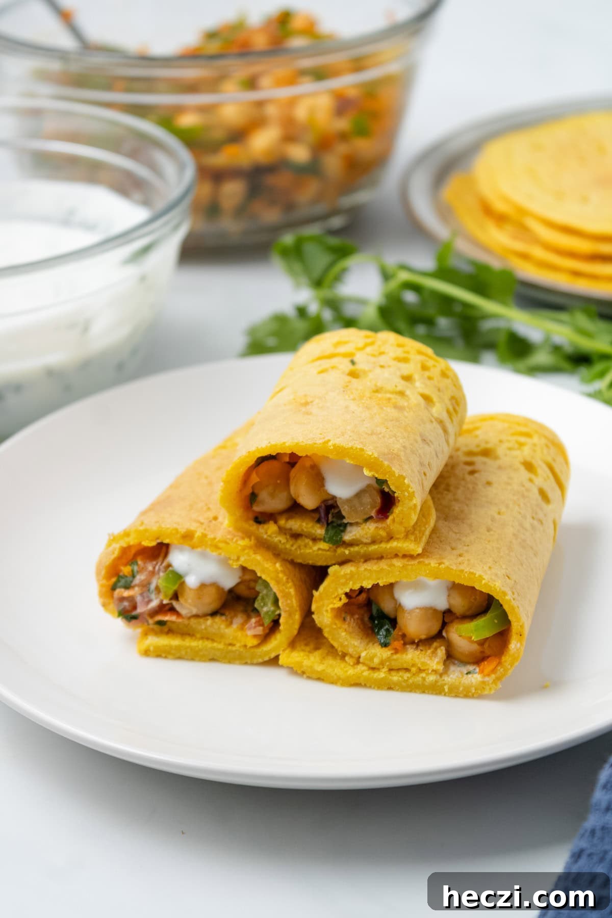 An image of three pieces of lentil wraps stacked on a plate.