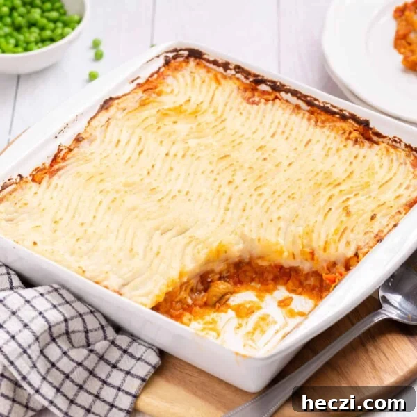 Close up view of vegan shepherd's pie in a white baking dish.