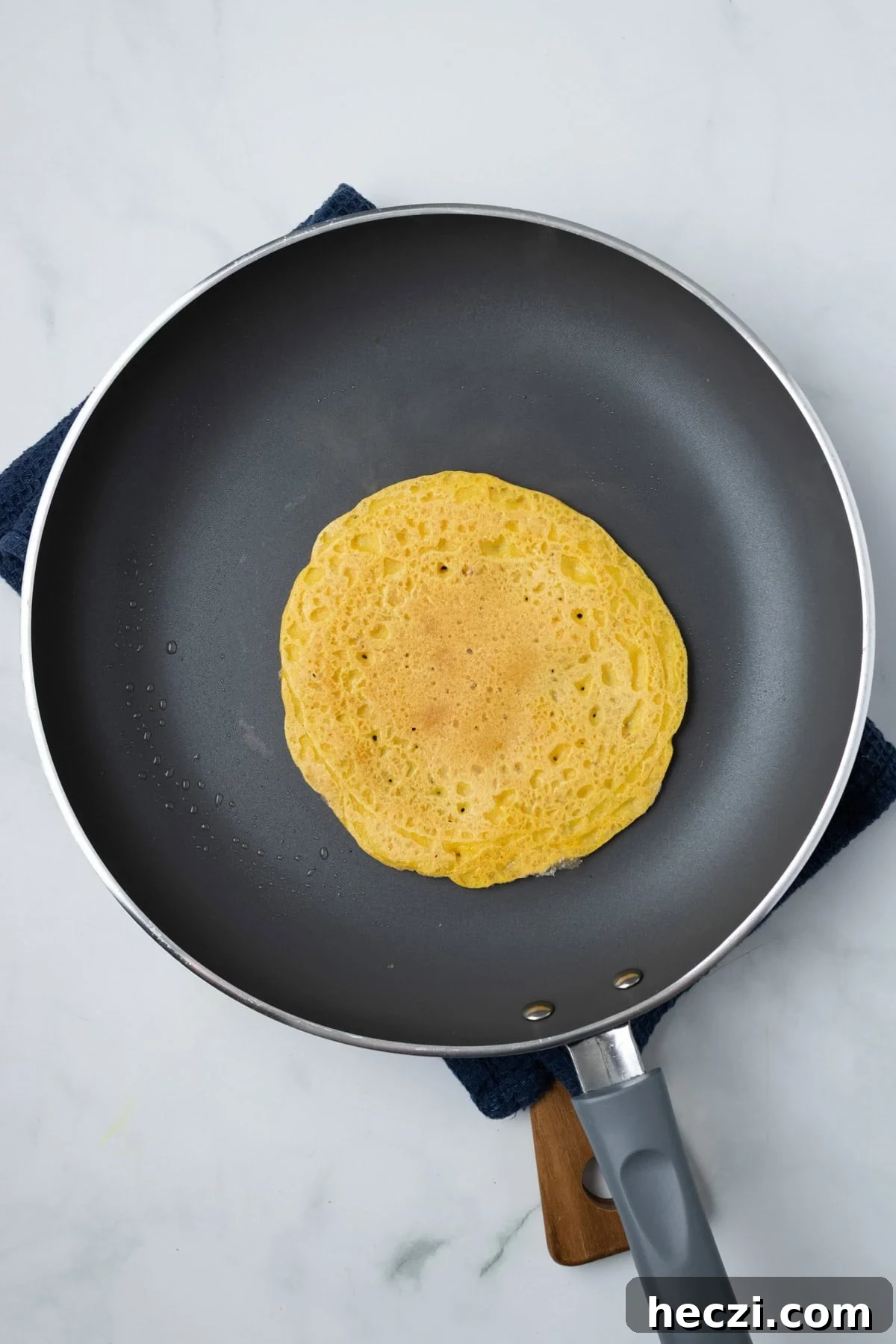 An overhead image of cooking red lentil mixture on pan.