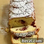 Shortcake loaf out of pan on parchment and sprinkled with powdered sugar.