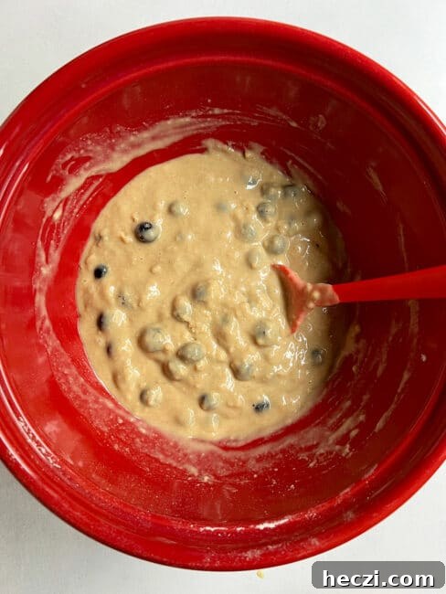 Blueberry cake batter in a red bowl ready to bake.