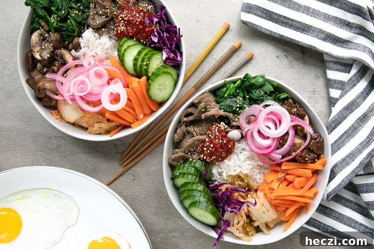 Overhead of bibimbap bowls with all the sides