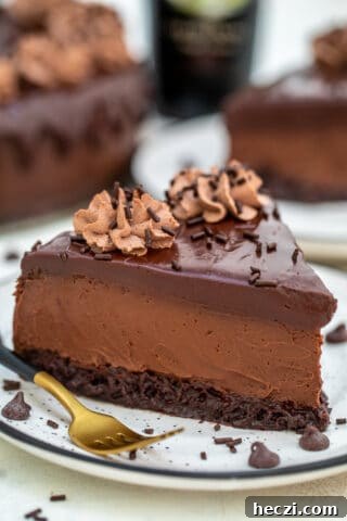 Brownie Baileys Cheesecake is decadent, chocolaty, dense, and extraordinary. It is everything that an elegant cheesecake should be and more! #baileys #stpatrickday #cheesecake #cheesecakerecipes #sweetandsavorymeals
