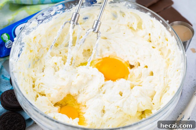 Whipping eggs into cream cheese mixture.
