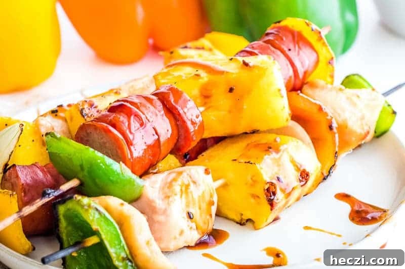 Teriyaki Chicken and Sausage Kabobs with Grilled Vegetables 4 Chicken Kebabs on white plate