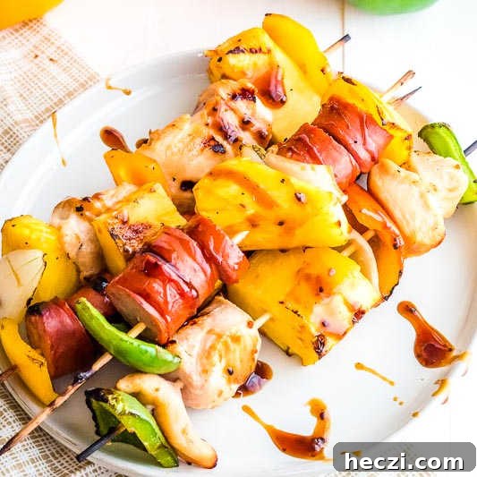 Teriyaki Chicken and Sausage Kabobs with Grilled Vegetables 5 Chicken and Sausage Kebabs on white plate