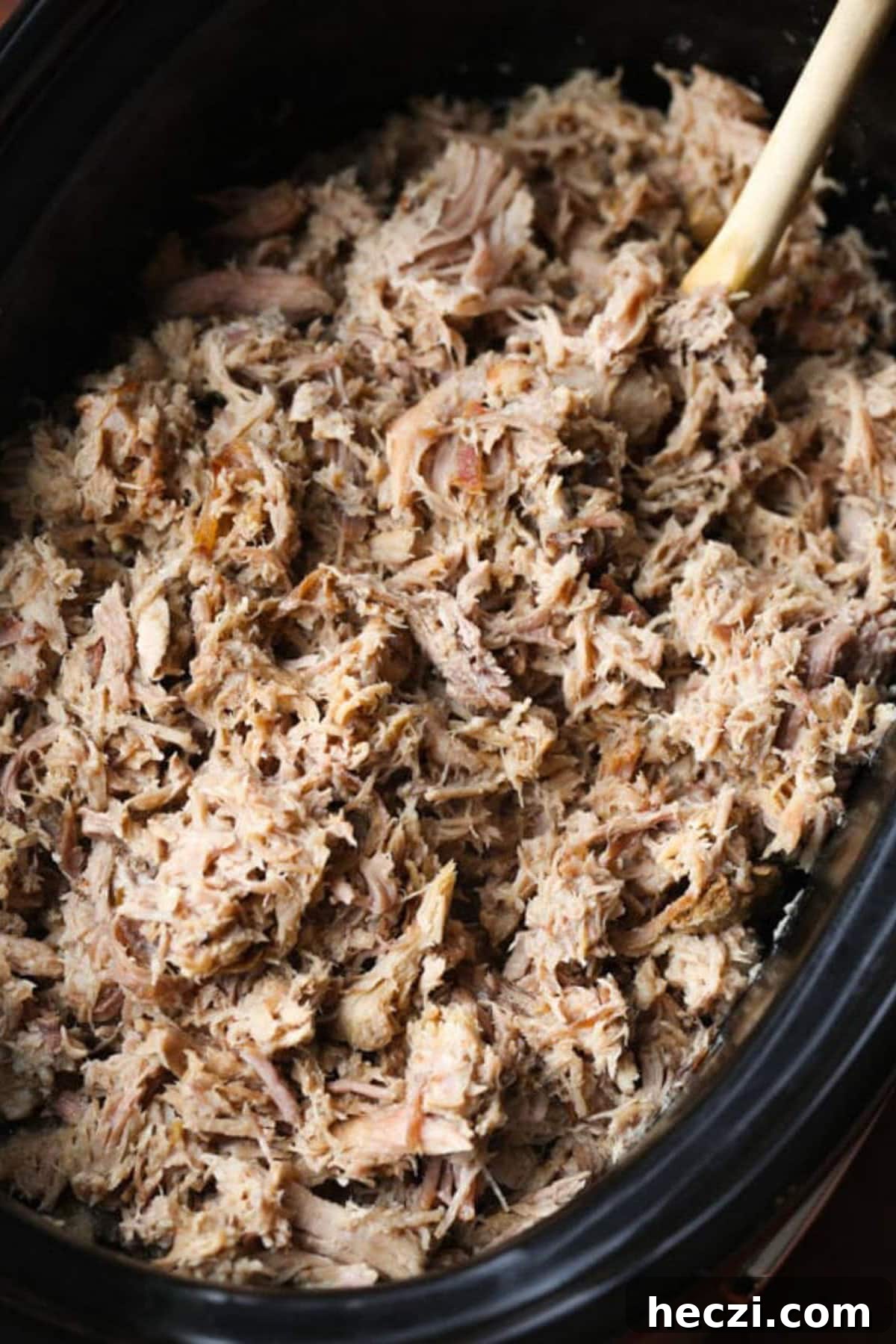 Shredded pulled Kalua pork in a crock pot.