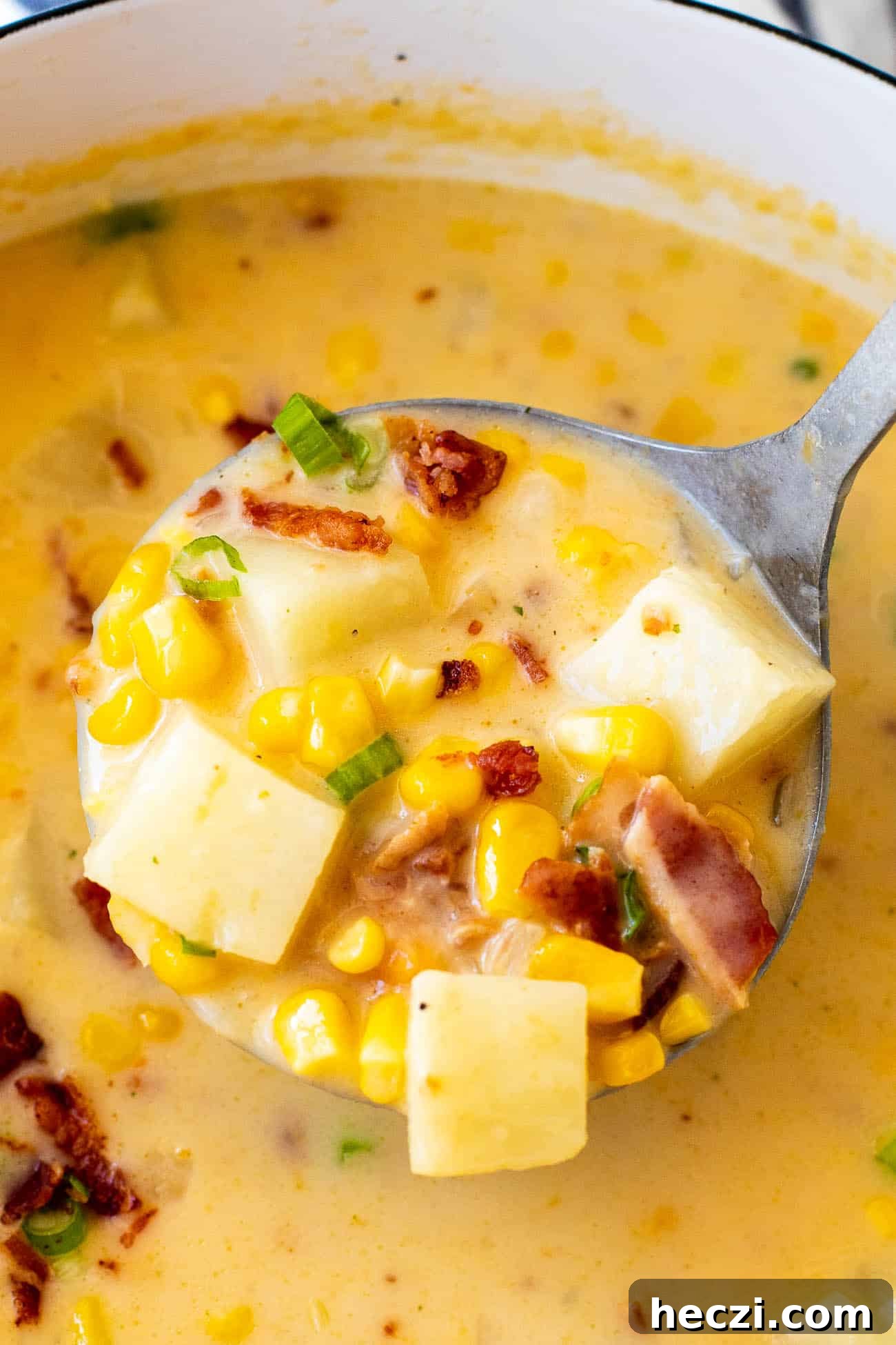 close up shot of a ladel of potato corn chowder recipe