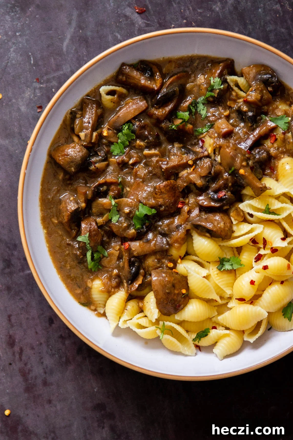 Garlic Mushrooms in the Instant Pot: Tender, Flavorful Side Dish 2 garlic mushrooms served alongside pasta in a white bowl