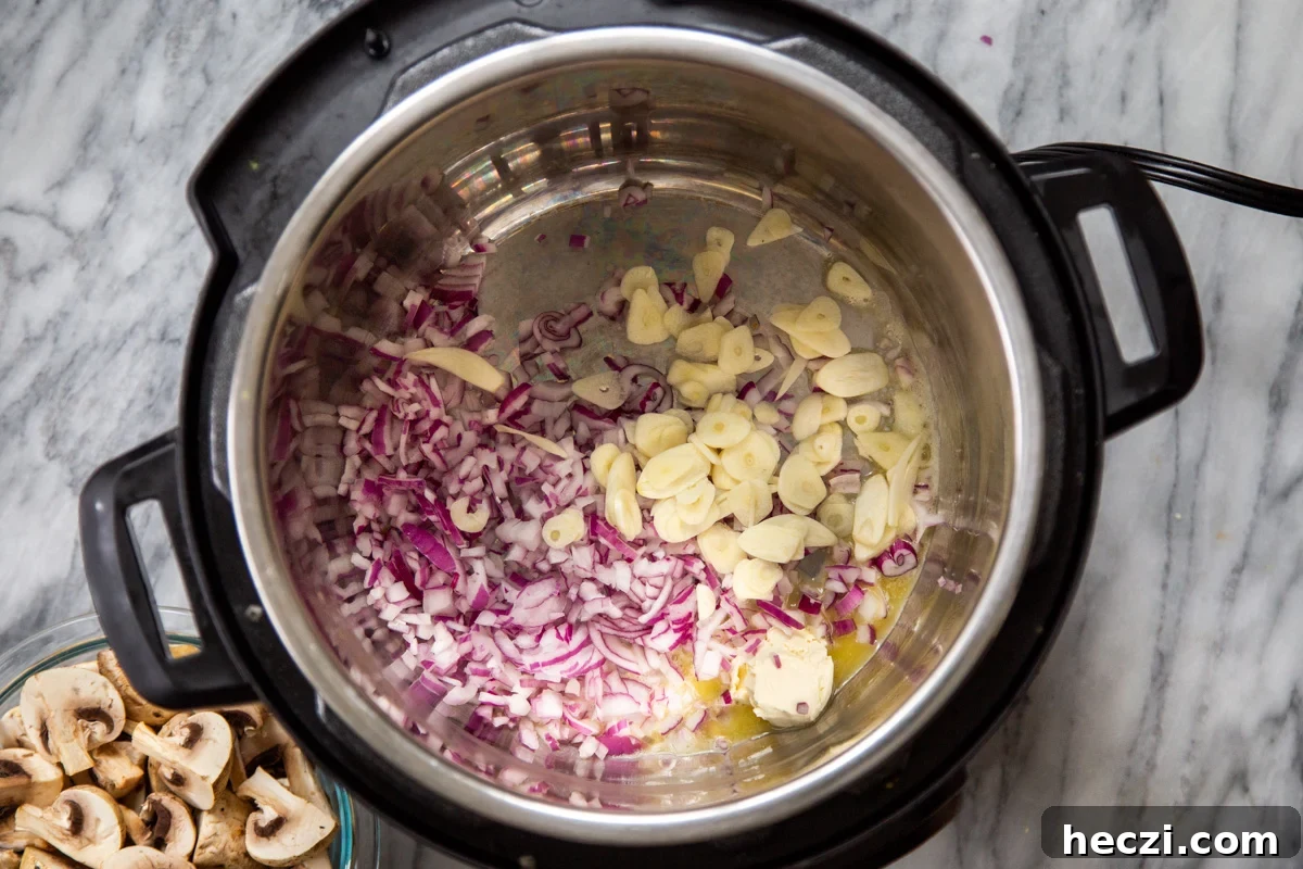 Garlic Mushrooms in the Instant Pot: Tender, Flavorful Side Dish 6 chopped red onion and sliced garlic in an Instant Pot