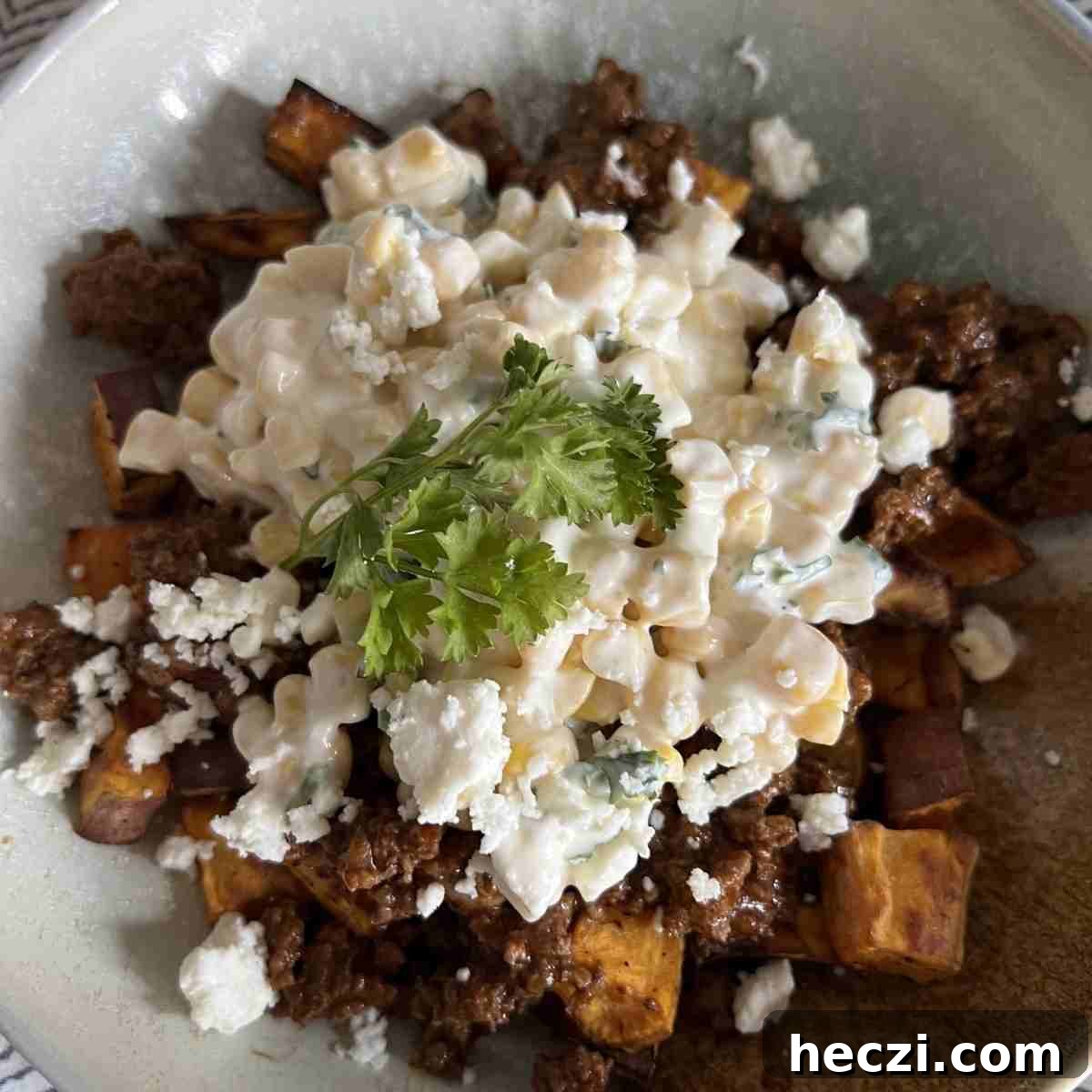 Mexican Street Corn Sweet Potato Bowls Recipe for Flavorful Meals 2 Mexican street corn sweet potato bowls topped with parsley.