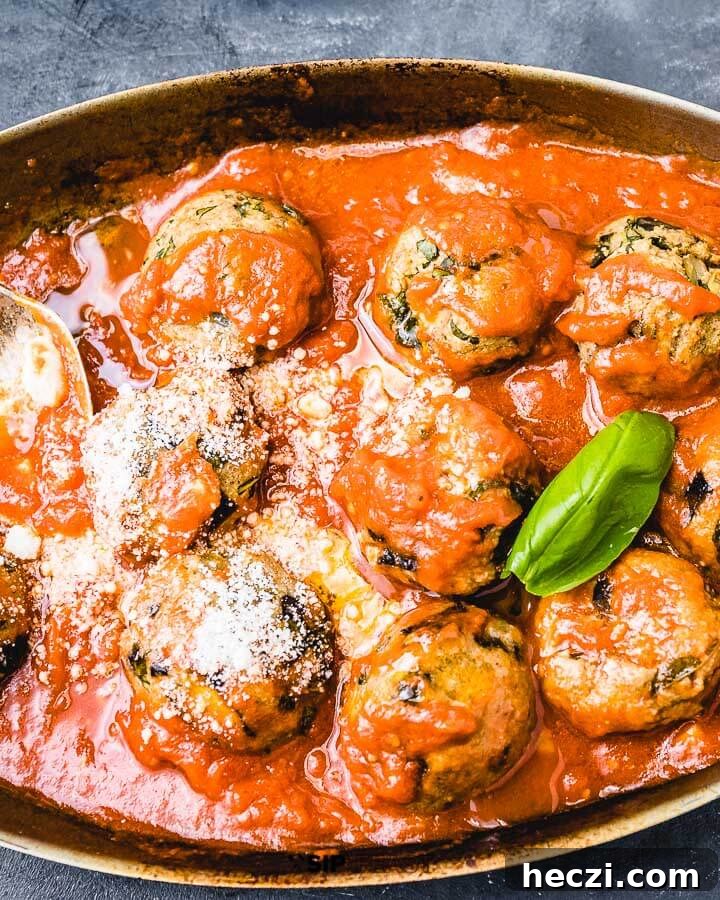 Eggplant Meatballs - sipandfeast.com #eggplantmeatballs #italianrecipes #eggplantrecipes Eggplant meatballs in pan on blue background.