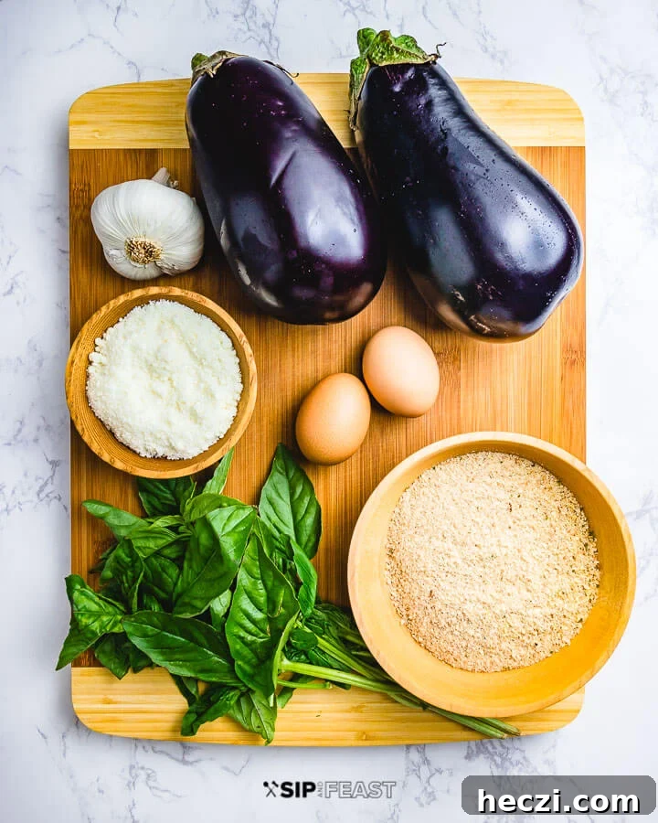 Eggplant Meatballs - sipandfeast.com #eggplantmeatballs #italianrecipes #eggplantrecipes Ingredients shown: garlic, 2 eggplants, Pecorino Romano, 2 eggs, bunch of basil and breadcrumbs.