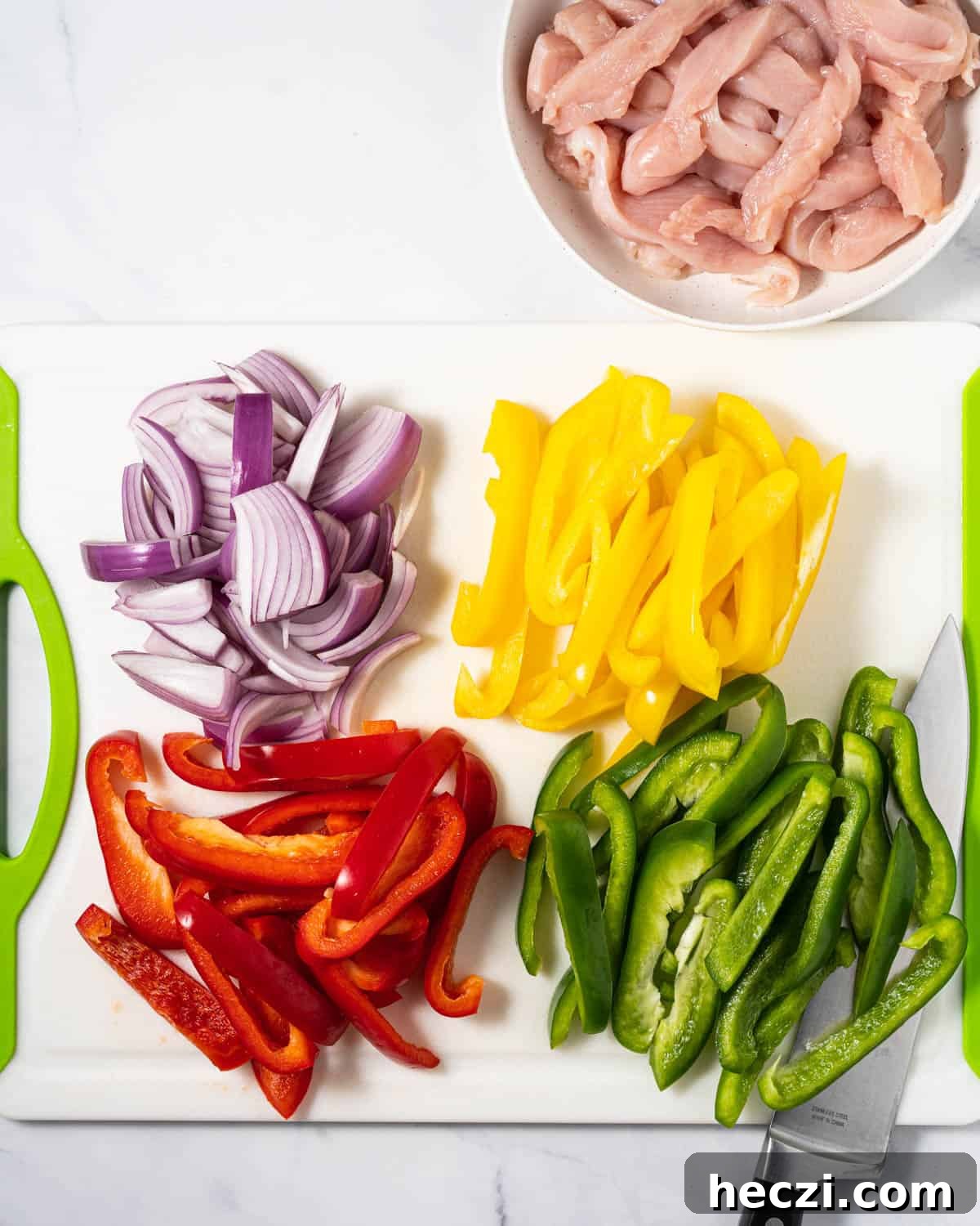 the process of slicing vegetables and chicken.