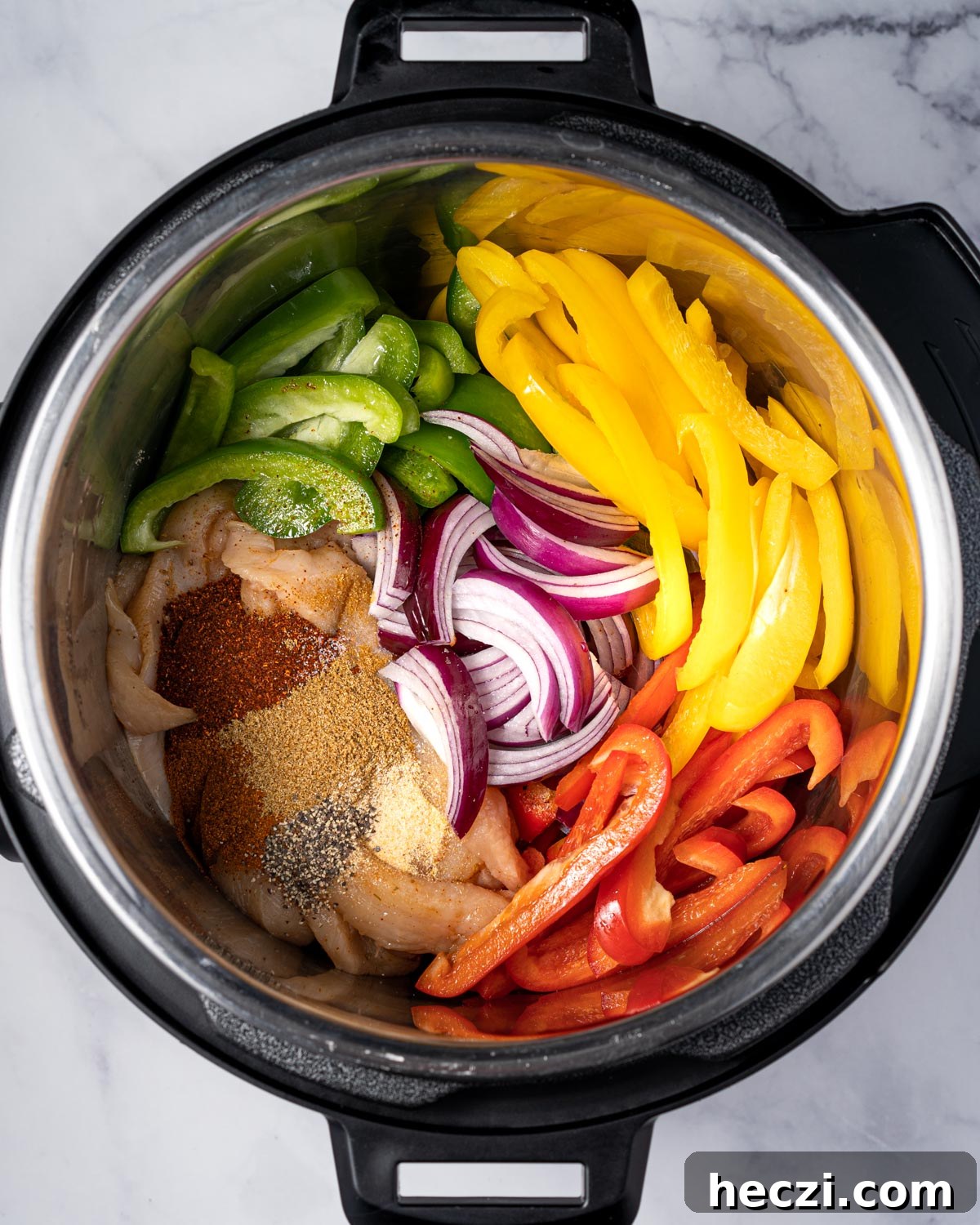chicken fajitas ingredients in the instant pot before pressure cooking.