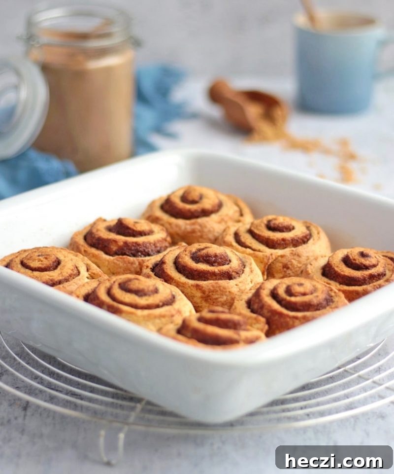 Baked rolls in a white ceramic dish on a round cooling rack