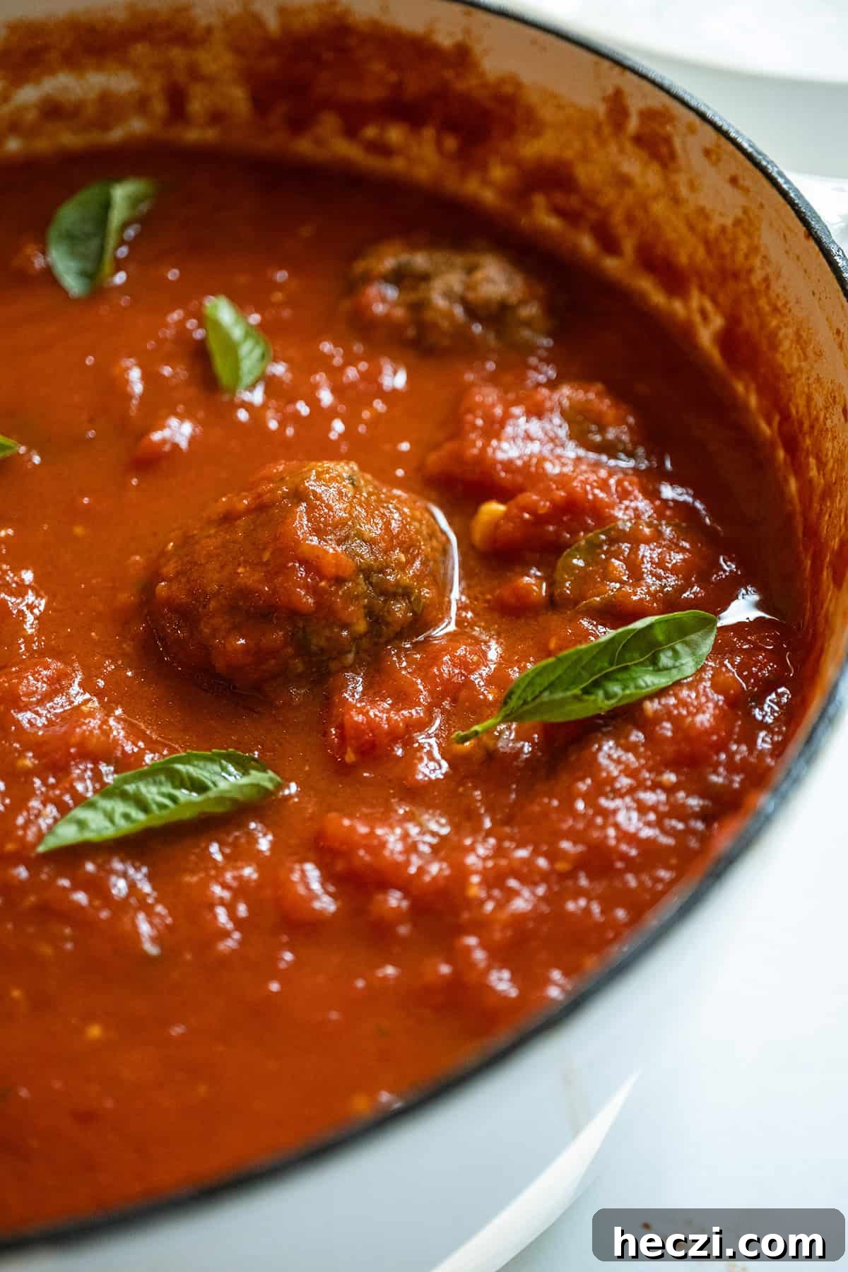 Homemade Italian Sunday Sauce Recipe for Classic Pasta Night 2 Sunday sauce with meatballs and sausage in a pot.