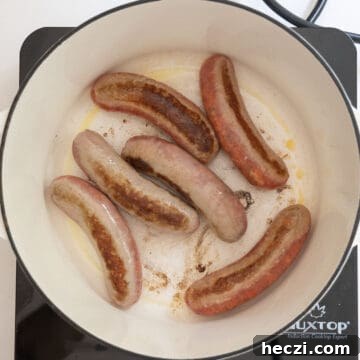 Homemade Italian Sunday Sauce Recipe for Classic Pasta Night 6 Searing sausage in the pot.