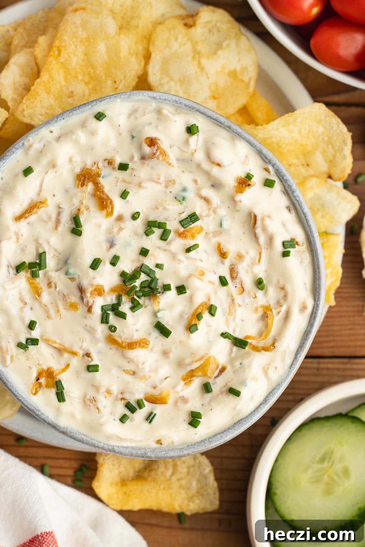 Caramelized Onion Dip with Greek Yogurt — Creamy Savory Recipe 2 This is a picture of the caramelized onion dip with greek yogurt surrounded with chips and veggies.