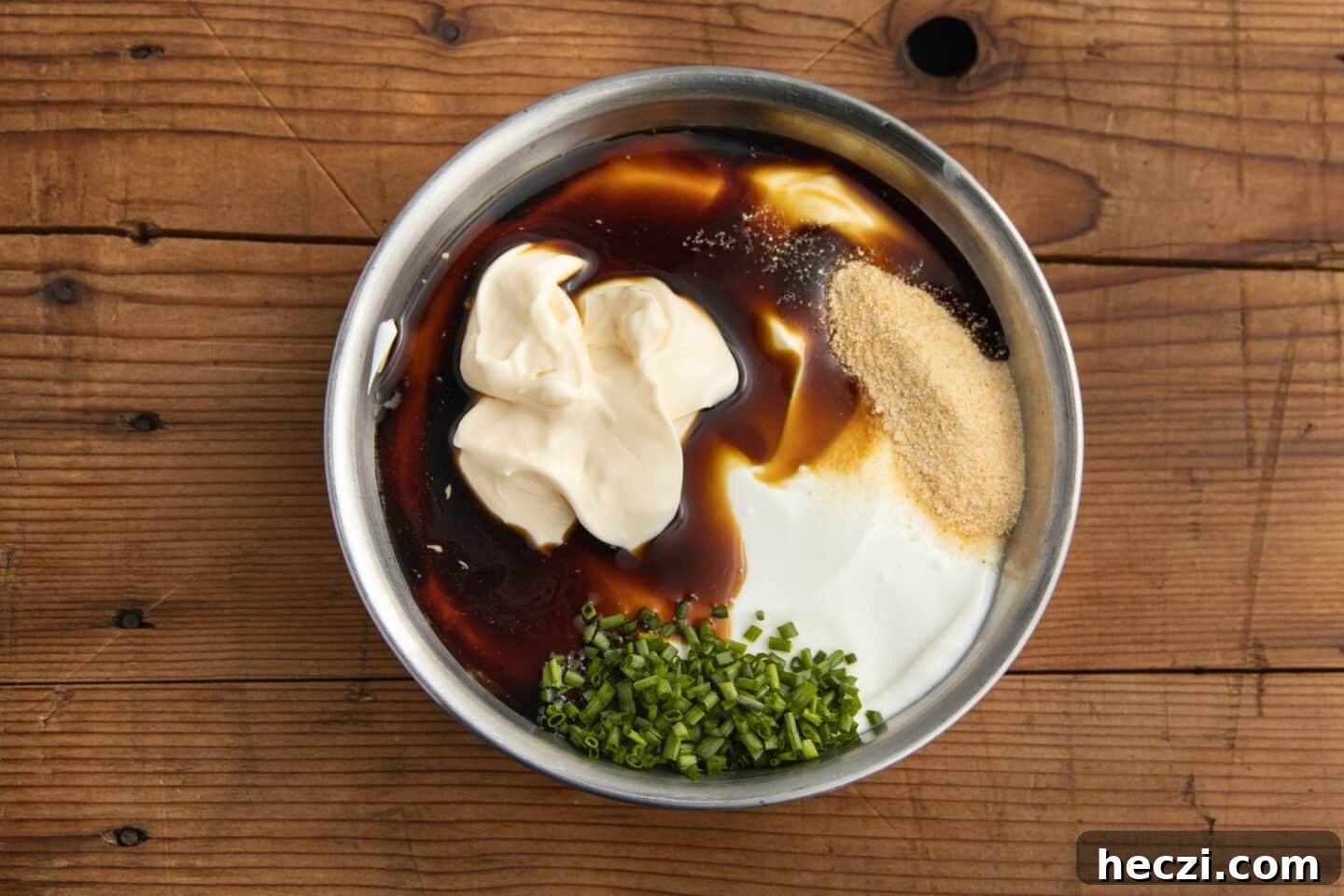 Caramelized Onion Dip with Greek Yogurt — Creamy Savory Recipe 7 This is a picture of a bowl with greek yogurt, mayo, seasoning, and chives.