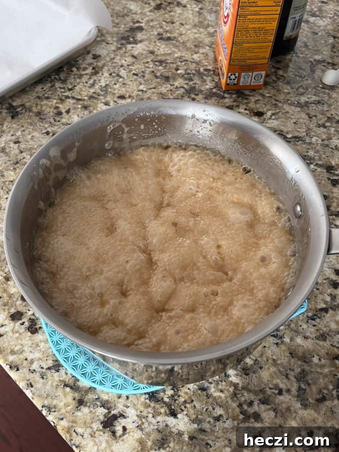 Classic Peanut Brittle Recipe: Crispy, Homemade Candy in 30 Minutes 13 peanut brittle mixture bubbling in a pot on a countertop
