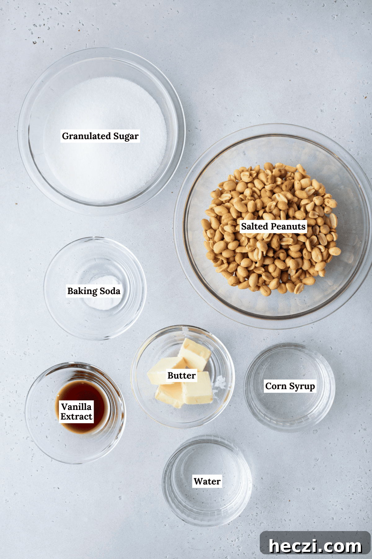 Classic Peanut Brittle Recipe: Crispy, Homemade Candy in 30 Minutes 5 over head shot of peanut brittle ingredients including peanuts, granulated sugar, butter, vanilla extract, baking soda, corn syrup and water