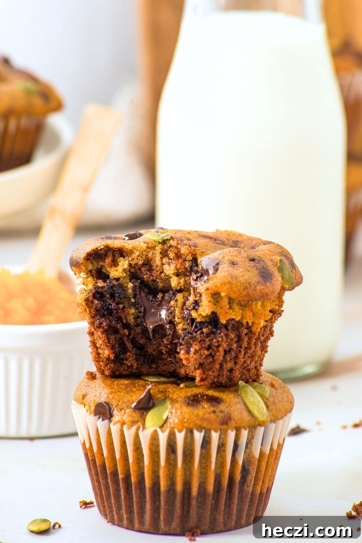 A stack of half-eaten gluten-free pumpkin chocolate chip muffins.