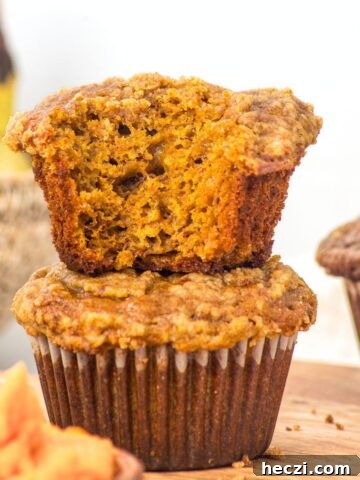 A stack of half-eaten gluten-free pumpkin banana muffins.