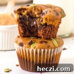 Gluten free pumpkin chocolate chip muffins stacked on top of each other.