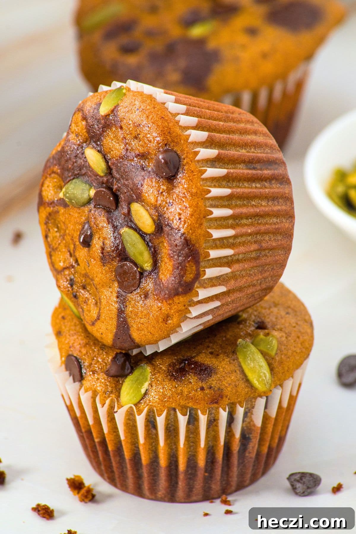 A stack of pumpkin and chocolate chip muffins.