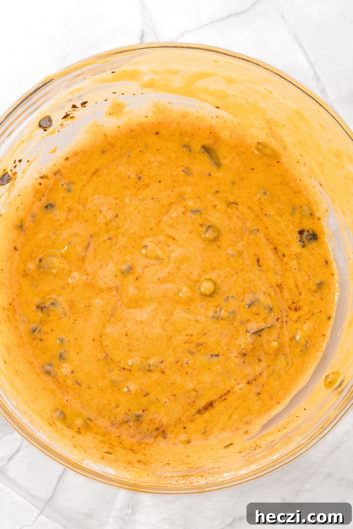 Yellow muffin batter in glass bowl