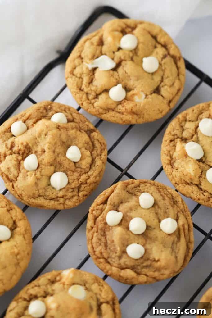 White Chocolate Chip Pumpkin Cookies: Soft Fall Cookie Recipe 2 how to make Pumpkin Cookies with White Chocolate Chips, the white chocolate chip pumpkin cookies are cooling on a wire rack.