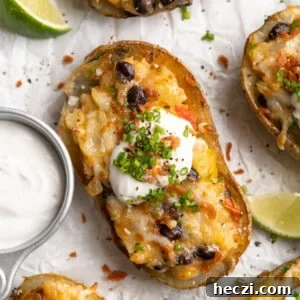Ultimate Loaded Potato Skins Recipe: Crispy, Cheesy & Bacon-Topped 2 Overhead view of healthy loaded potato skin topped with chives, vegan bacon, and sour cream