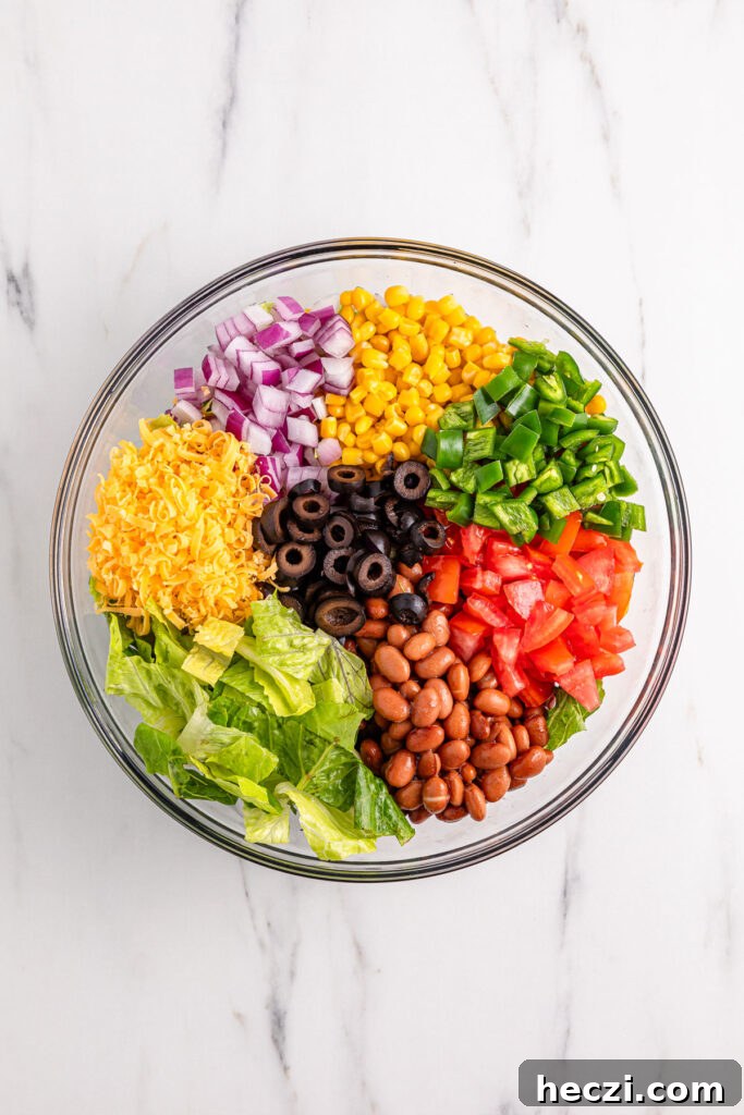 mixing ingredients for Doritos taco salad