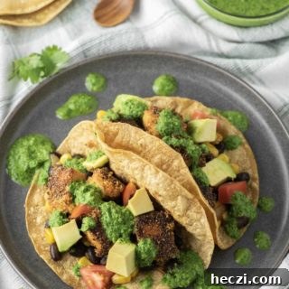 Crispy Tofu Tacos with Zesty Slaw and Avocado crema 12 Two tofu tacos on plate.