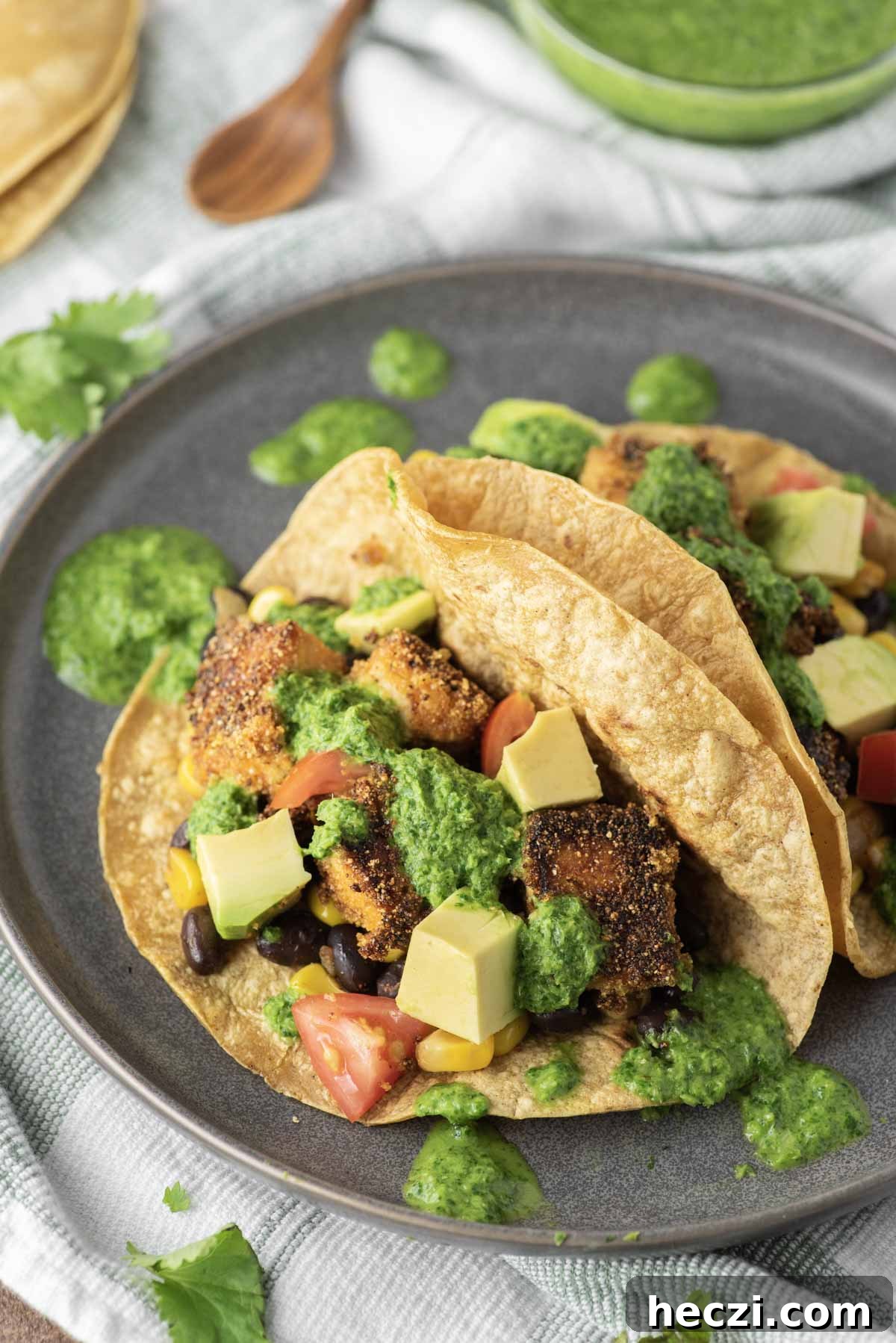 Crispy Tofu Tacos with Zesty Slaw and Avocado crema 7 tofu tacos on slate gray plate