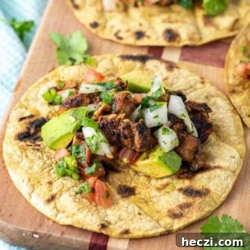 Grilled chicken street tacos on cutting board.