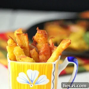 Apple fritters served in a yellow and blue mug