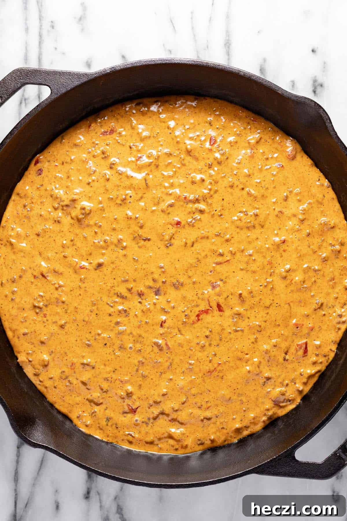 Creamy Rotel Dip Recipe with Cheesy Sausage for Parties 6 Cast iron skilled filled with cheesy Velveeta rotel dip.