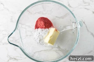 Strawberry Cream Cheese Frosting Recipe for Cakes & Cupcakes 7 Mixing the powdered sugar, strawberry powder and butter together.