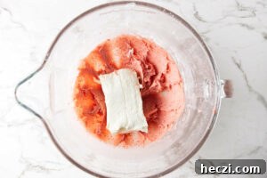 Strawberry Cream Cheese Frosting Recipe for Cakes & Cupcakes 9 Adding cream cheese to the buttercream mixture.