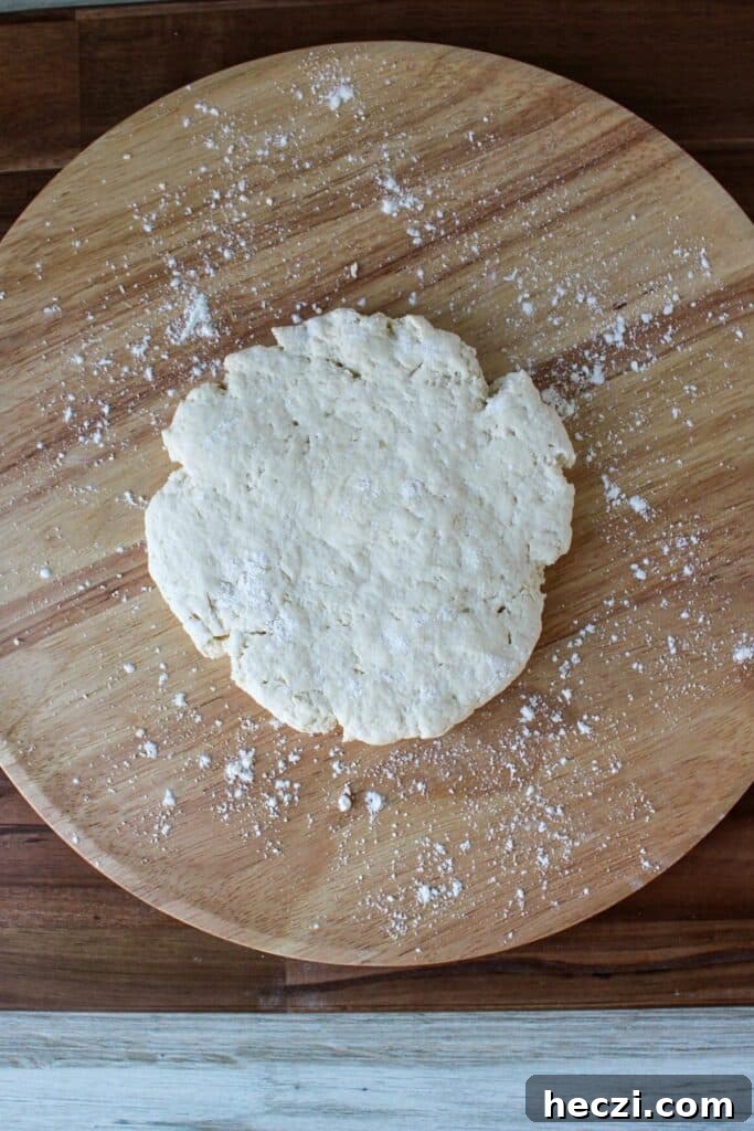 Air Fryer Cinnamon Roll Bites Made with 2-Ingredient Dough 5 Two ingredient dough on a wooden board.