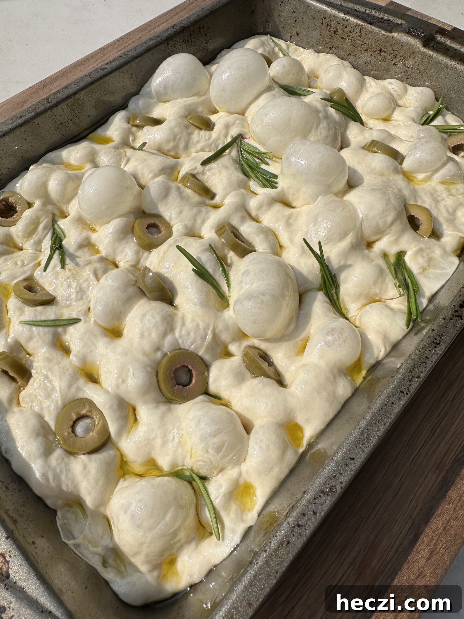 Authentic Italian Focaccia Recipe for Crispy, Flavorful Bread 7 Raw focaccia bread with herbs