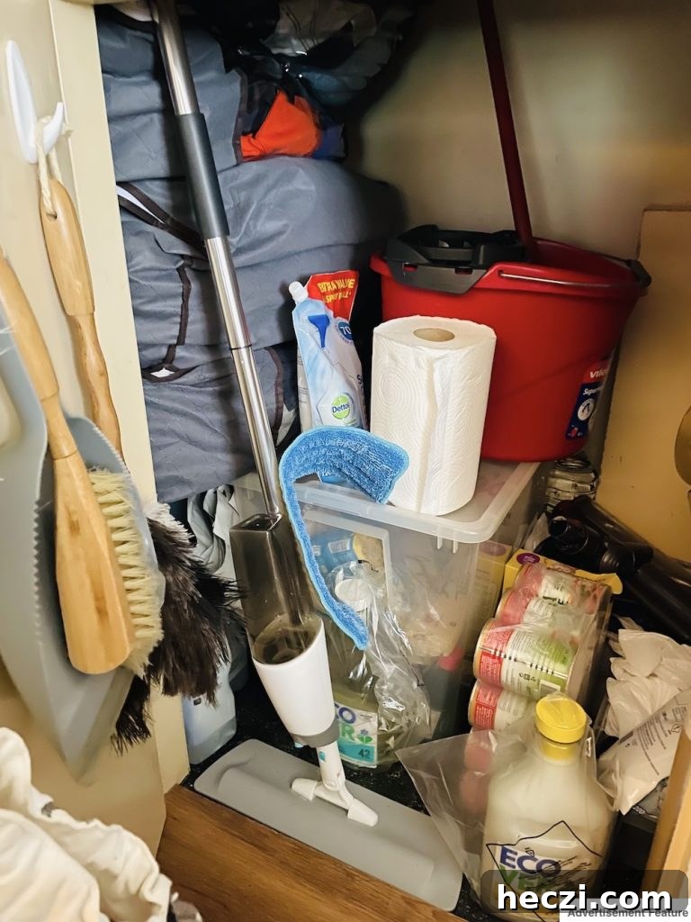 messy under-stair storage cupboard